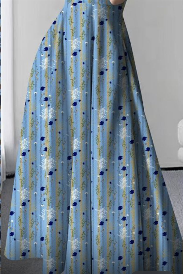 Wearing a long, flowing dress sewn from Super Cheap Fabrics' Designer Rayon - Fieldstripe Bloom (145cm), featuring blue and white floral and striped patterns, partially revealing the upper body indoors.