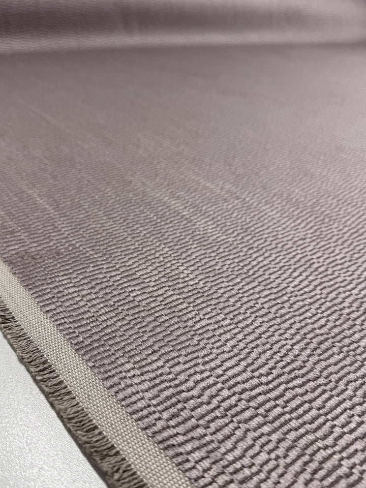Close-up of Super Cheap Fabrics’ Upholstery Jacquard - Oscar Dusk (142cm), showing its textured mauve heavyweight fabric, subtle pattern, and premium stitching—a perfect choice for quality upholstery projects.