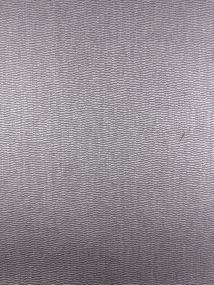 Close-up of Super Cheap Fabrics' Upholstery Jacquard – Oscar Dusk (142cm), a premium Australian gray fabric with subtle, irregular wavy lines forming uneven rectangles and a smooth, slightly lustrous surface—perfect for heavyweight upholstery.