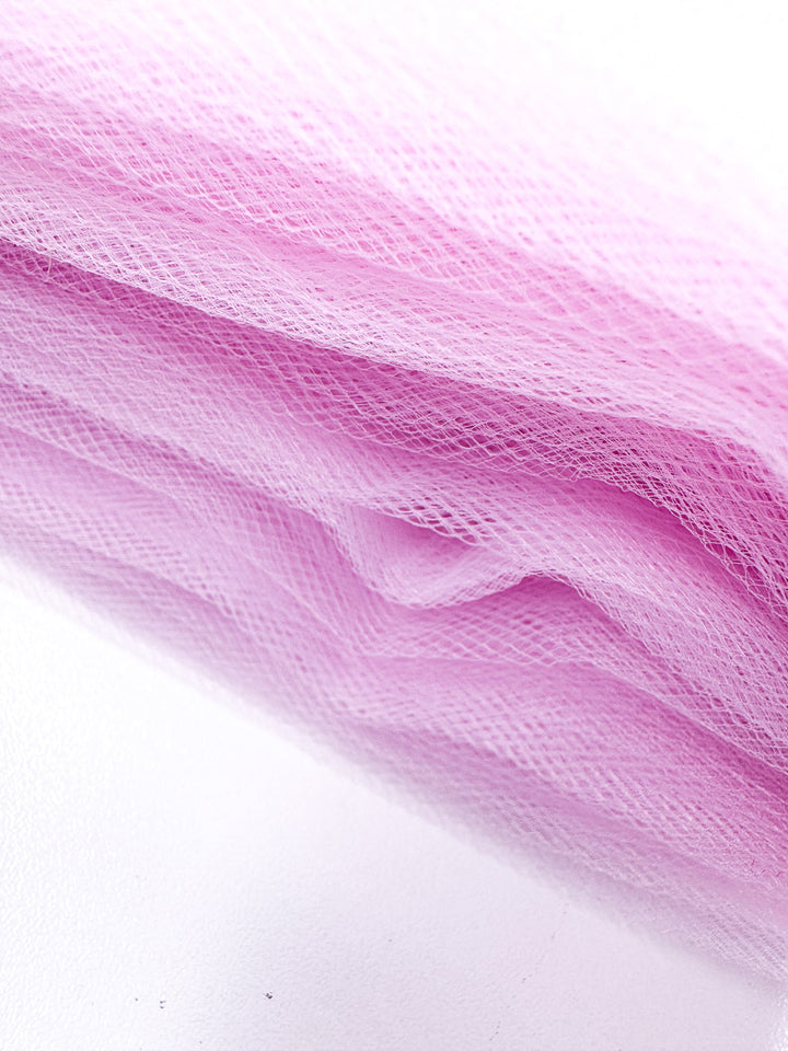 Close-up of Soft Tulle - Baby Pink - 150cm by Super Cheap Fabrics, showcasing its delicate mesh texture, soft translucent look, and gentle folds—ideal for bridal veils or costumes.