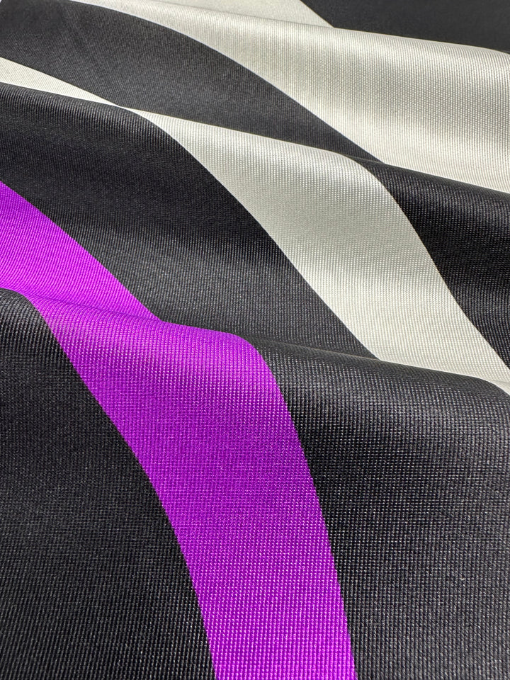 Image of Super Cheap Fabrics' Silk Twill Panel - Crop - 145cm featuring luxurious diagonal stripes in black, white, and vibrant magenta. The texture is smooth with a subtle sheen, showcasing the bold color contrast and pattern.