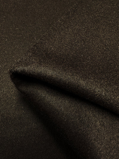 Close-up of the Melton Wool - Hot Fudge - 155cm by Super Cheap Fabrics. The dark brown, soft-textured heavy weight wool is folded neatly in layers, showcasing its rich, plush surface and fine weave. The lighting highlights the material's luxurious sheen and smooth finish.