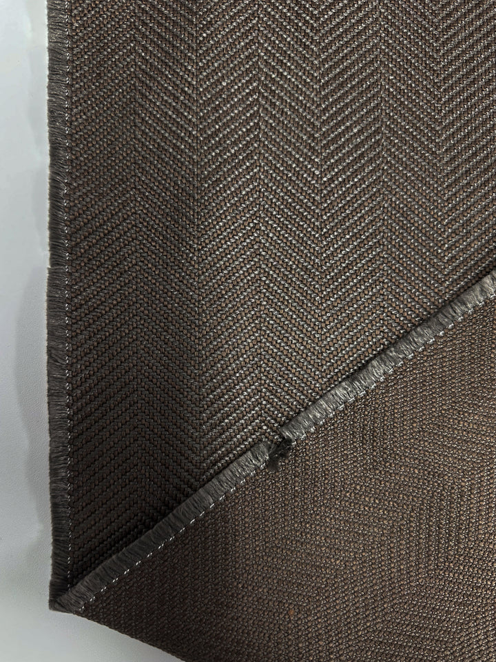 Close-up of Super Cheap Fabrics’ Upholstery - Montpellier 15 - 145cm, highlighting the subtle herringbone pattern, folded corner, and frayed edges. The premium Australian fabric’s texture and weave are clearly shown.