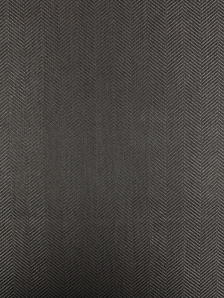 Close-up of Super Cheap Fabrics’ Upholstery - Montpellier 15 (145cm), a dark gray heavyweight upholstery fabric with a subtle vertical herringbone zigzag pattern, highlighting its premium woven texture and quality.