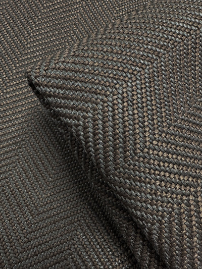 Close-up of Super Cheap Fabrics' Upholstery - Montpellier 15 - 145cm, a dark brown, textured woven fabric with a subtle chevron pattern. A folded corner highlights the intricate weave and quality of this premium Australian upholstery material.