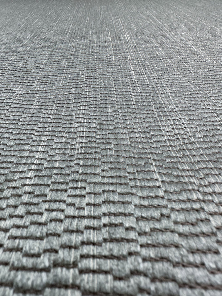 Close-up of Super Cheap Fabrics’ Cut Pile Jacquard Upholstery - Oscar Gunmetal (142cm), showing its textured gray surface with a rectangular grid pattern for added depth and visual interest.