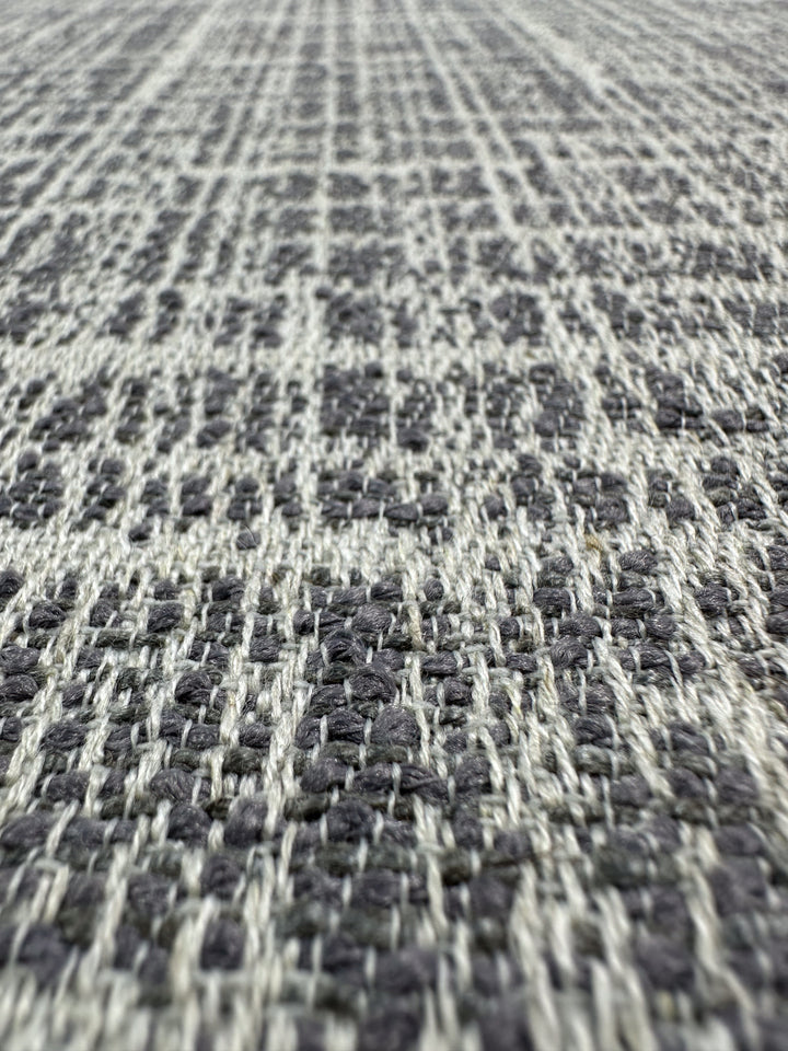 Close-up of Super Cheap Fabrics' Textured Weave Upholstery - Dexter 33 Dove (147cm), showcasing its gray and white checkered pattern and premium woven texture.