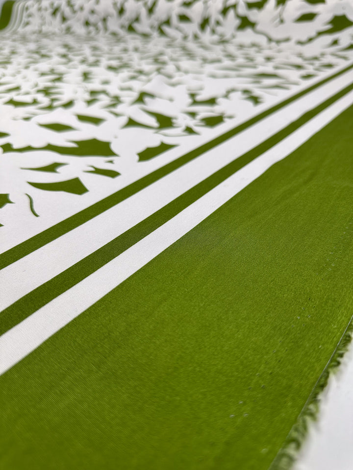 Close-up of Designer Rayon - Olive Fade by Super Cheap Fabrics: a 145cm-wide green and white rayon with bold olive stripes and leafy patterns, offering a textured, vibrant designer look.