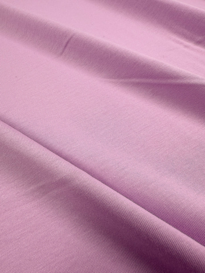 A close-up of Super Cheap Fabrics' Cotton Jersey - Orchid Bouquet (165cm), highlighting its light to medium weight and soft texture.