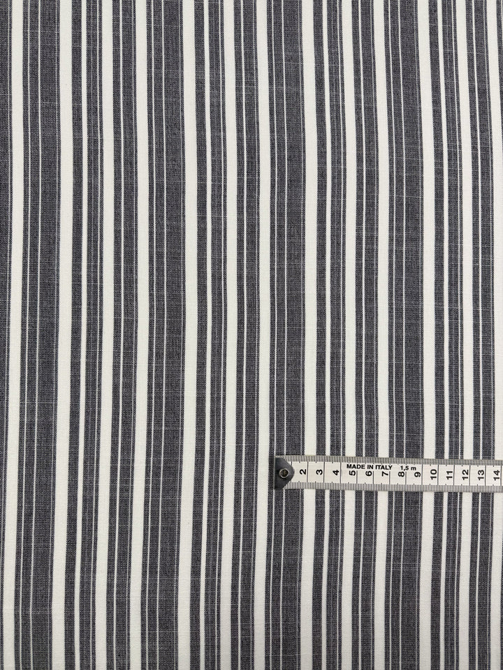 The Linen Blend - Linen Stripe - 150cm by Super Cheap Fabrics features lightweight black and white vertical stripes, with a measuring tape in the bottom right showing centimeters up to 15 cm for scale.