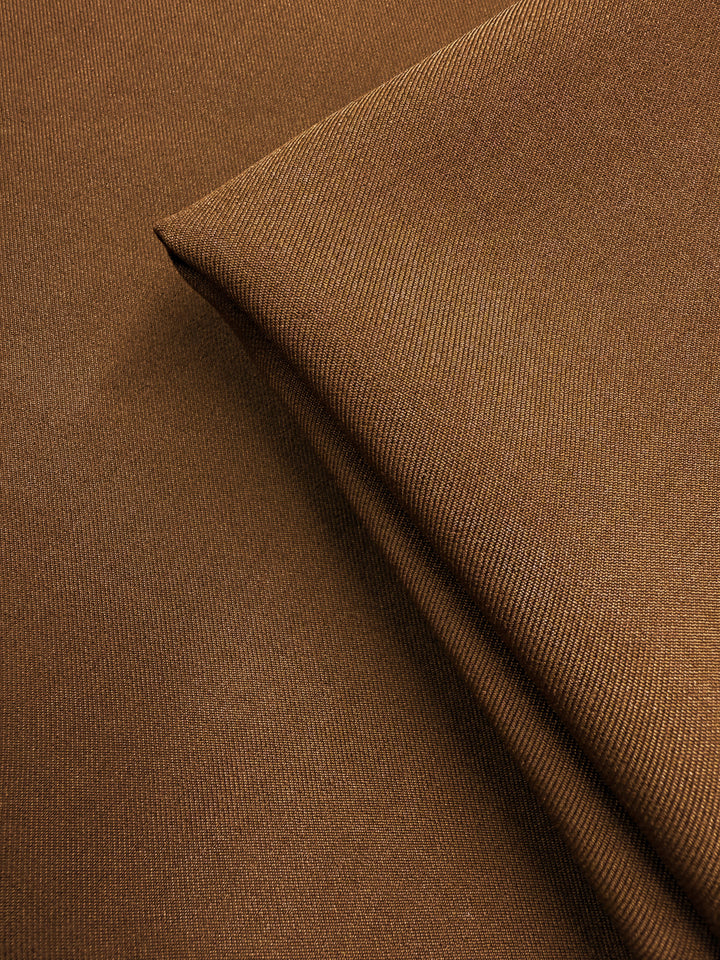 Close-up of Liquid Twill - Caramel Cafe (150cm) by Super Cheap Fabrics, featuring a smooth, medium-weight caramel brown diagonal weave—perfect for tailored garments.