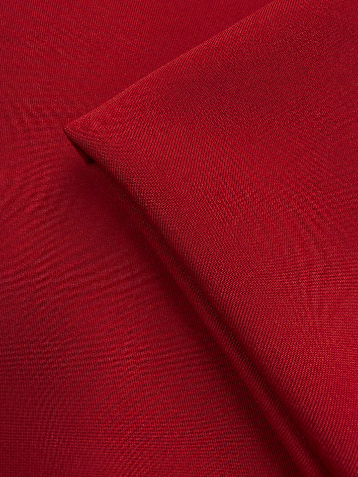 Close-up of two overlapping pieces of Liquid Twill - Rythmic Red (150cm) from Super Cheap Fabrics, highlighting the smooth texture, fine weave, and subtle folds.