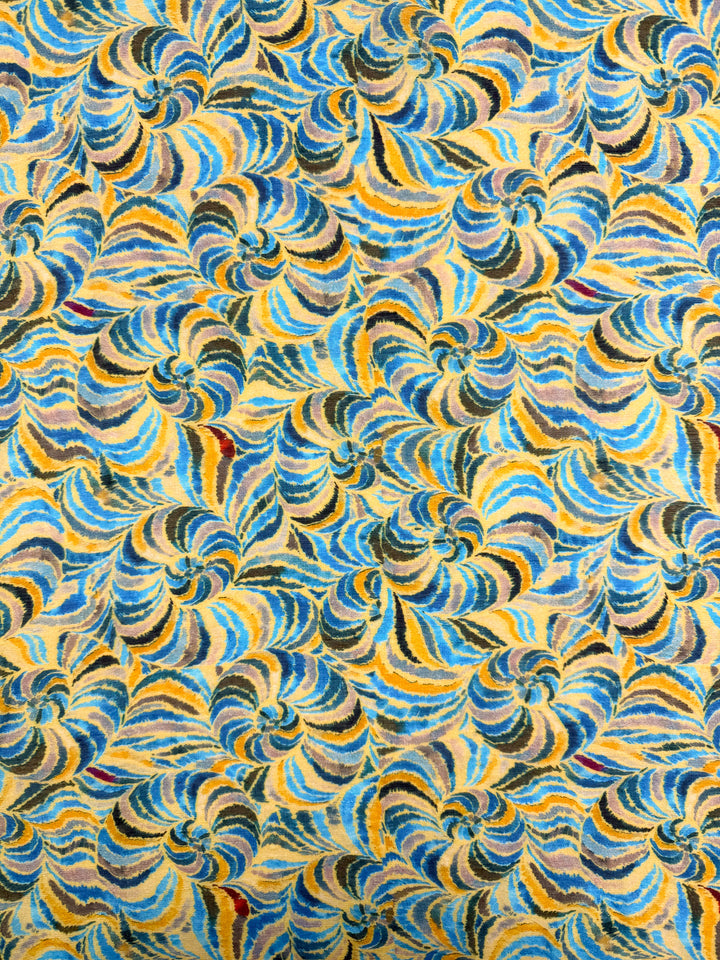 Spiral Sun by Super Cheap Fabrics features a vibrant, energetic abstract pattern of swirling blue, yellow, black, and red on beige—perfect for modern projects with this 145cm lightweight cotton: Textured Designer Cotton - Spiral Sun.