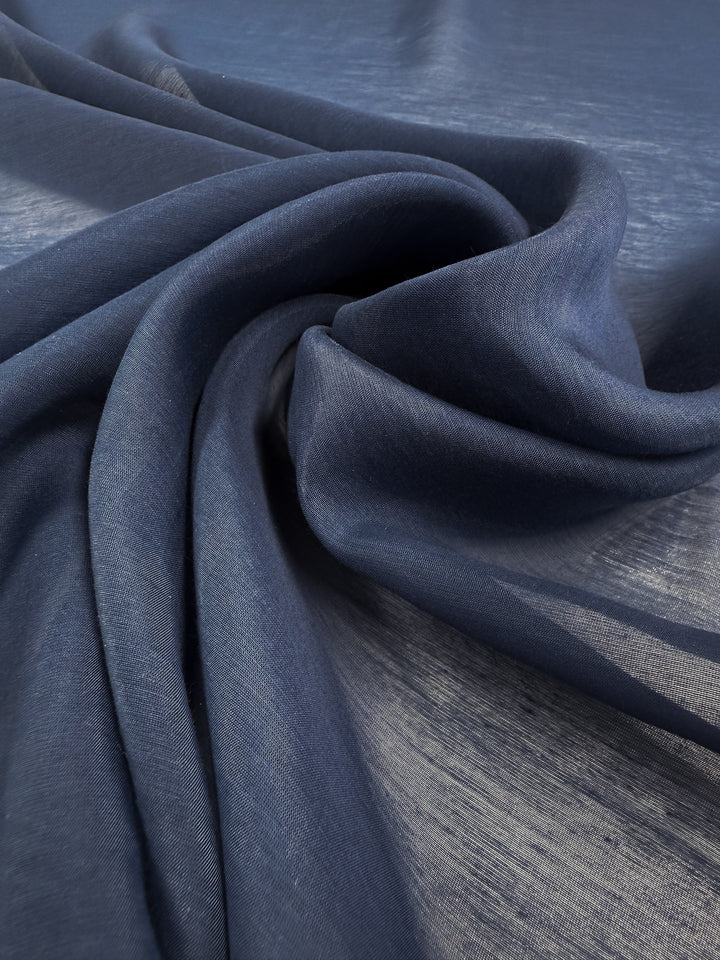A close-up of Designer Voile - Pageant Blue - 150cm by Super Cheap Fabrics, featuring soft, flowing folds and a subtle sheen—ideal for summer dresses or any lightweight fabric project.