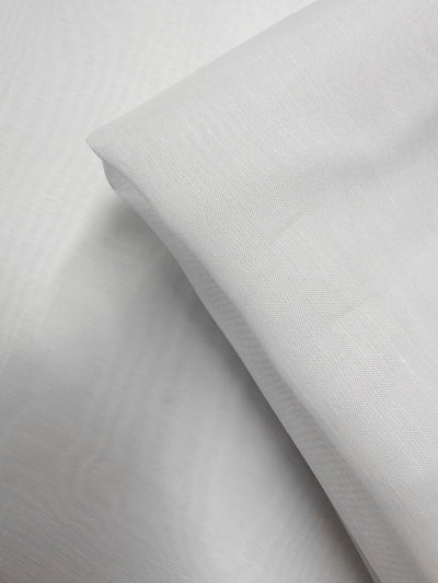 A close-up of Designer Voile - White - 150cm by Super Cheap Fabrics shows its smooth, lightweight texture and gentle folds in overlapping layers.