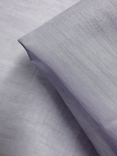 A close-up of Designer Voile - Pastel Lilac - 150cm from Super Cheap Fabrics, showing its fine, smooth texture and neat fold—ideal for those wanting elegant, lightweight cotton voile.