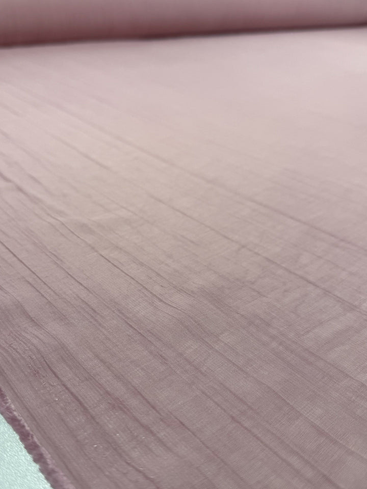 A close-up of Super Cheap Fabrics’ Textured Designer Voile - Silver Pink (155cm), featuring a subtle crinkled texture—ideal for airy summer dresses.