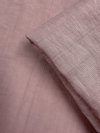A close-up of Super Cheap Fabrics’ Textured Designer Voile - Silver Pink (155cm) reveals its subtle pattern and gentle drape—an ideal lightweight fabric for creating elegant summer dresses.