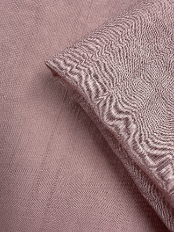 A close-up of Super Cheap Fabrics’ Textured Designer Voile - Silver Pink (155cm) reveals its subtle pattern and gentle drape—an ideal lightweight fabric for creating elegant summer dresses.