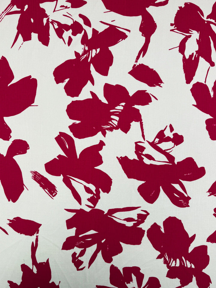 Super Cheap Fabrics’ Bamboo Rayon - Crimson Bloom - 150cm features bold red abstract floral patterns on white, ideal for lightweight projects or beginner sewing with its artistic brushstroke-inspired design.