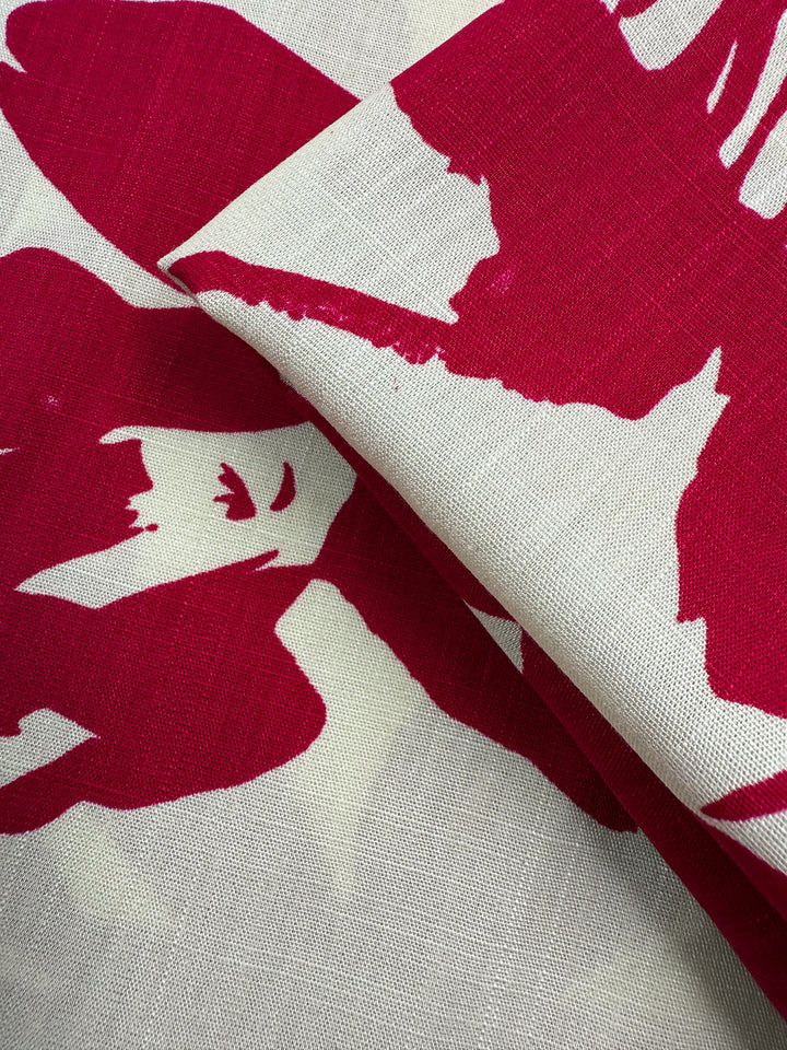 Super Cheap Fabrics' Bamboo Rayon - Crimson Bloom (150cm) is a lightweight, red and off-white fabric with a bold abstract floral pattern—folded to show texture and overlapping shapes, ideal for beginner sewing projects.
