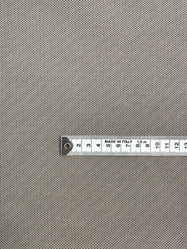 A close-up of the Printed Bengaline - Pin Dot Sand by Super Cheap Fabrics shows a comfortable, structured fabric with fine dots. A silver tape marked "Made in Italy" runs diagonally from 0 to 15 cm at the bottom right.